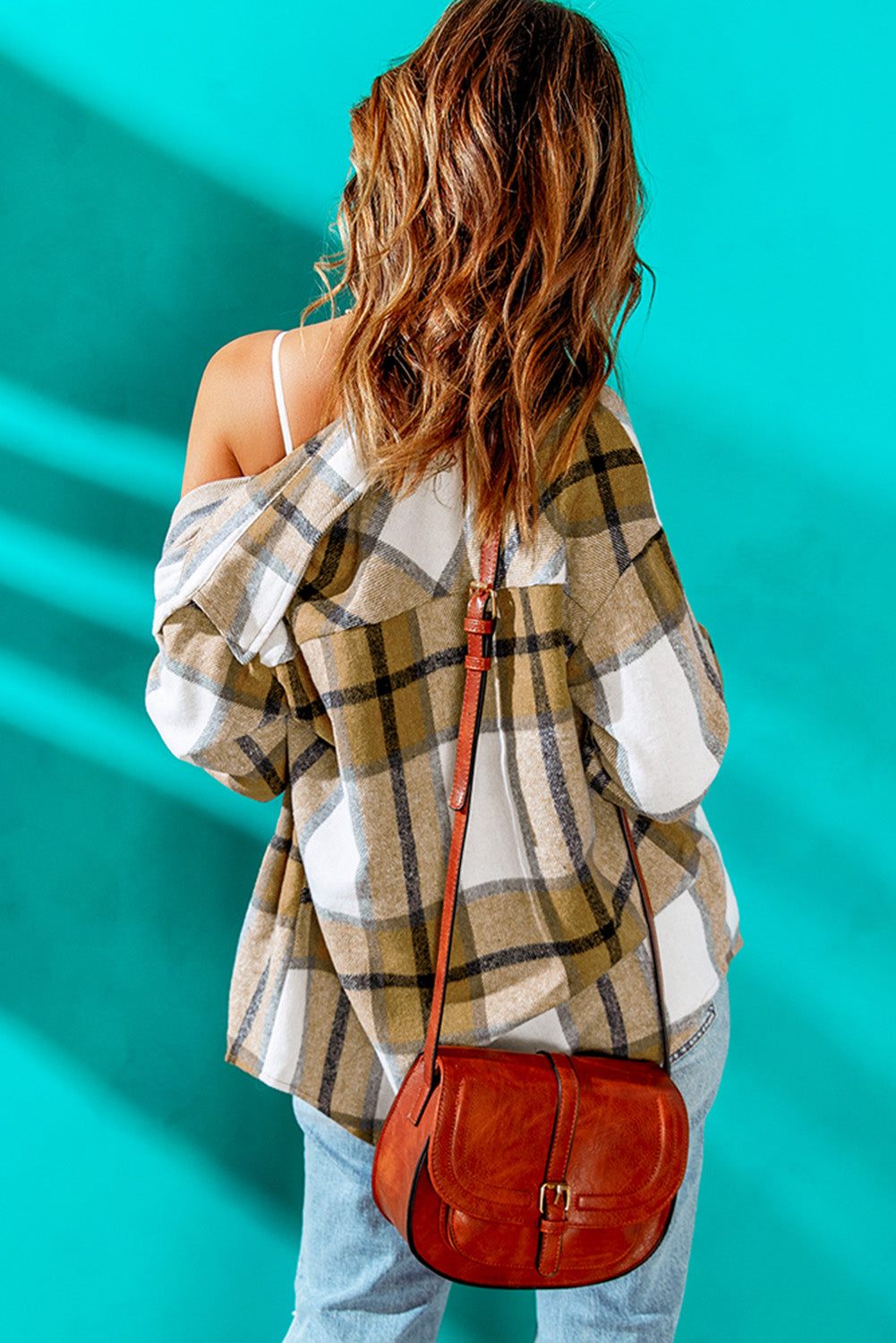 Khaki button-up pocket plaid shacket displayed on a mannequin, featuring a stylish plaid pattern and front pockets.