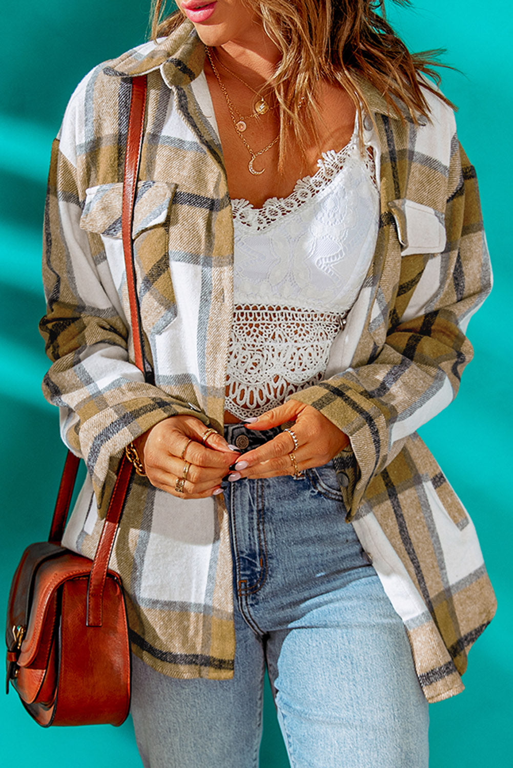 Khaki button-up pocket plaid shacket displayed on a mannequin, featuring a stylish plaid pattern and front pockets.