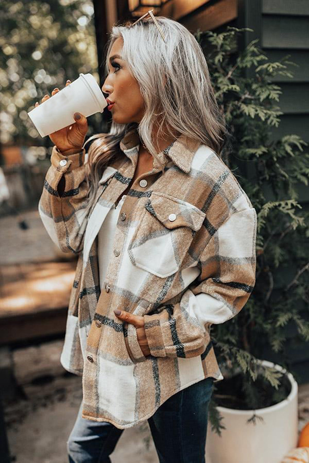 Khaki button-up pocket plaid shacket displayed on a mannequin, featuring a stylish plaid pattern and front pockets.