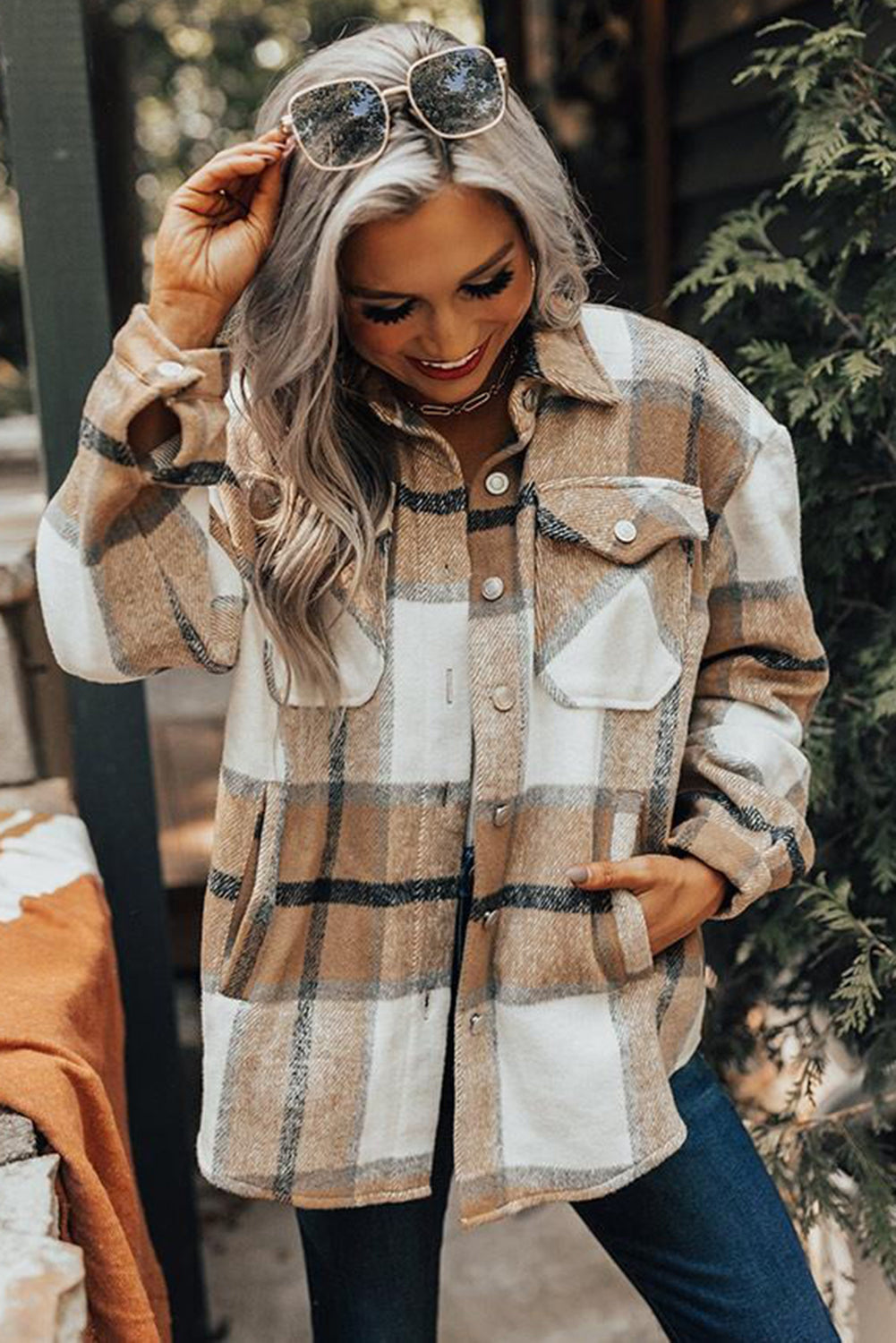 Khaki button-up pocket plaid shacket displayed on a mannequin, featuring a stylish plaid pattern and front pockets.