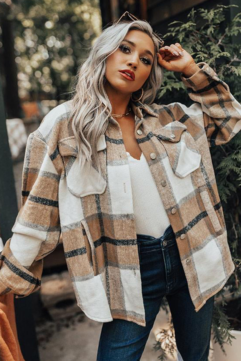 Khaki button-up pocket plaid shacket displayed on a mannequin, featuring a stylish plaid pattern and front pockets.