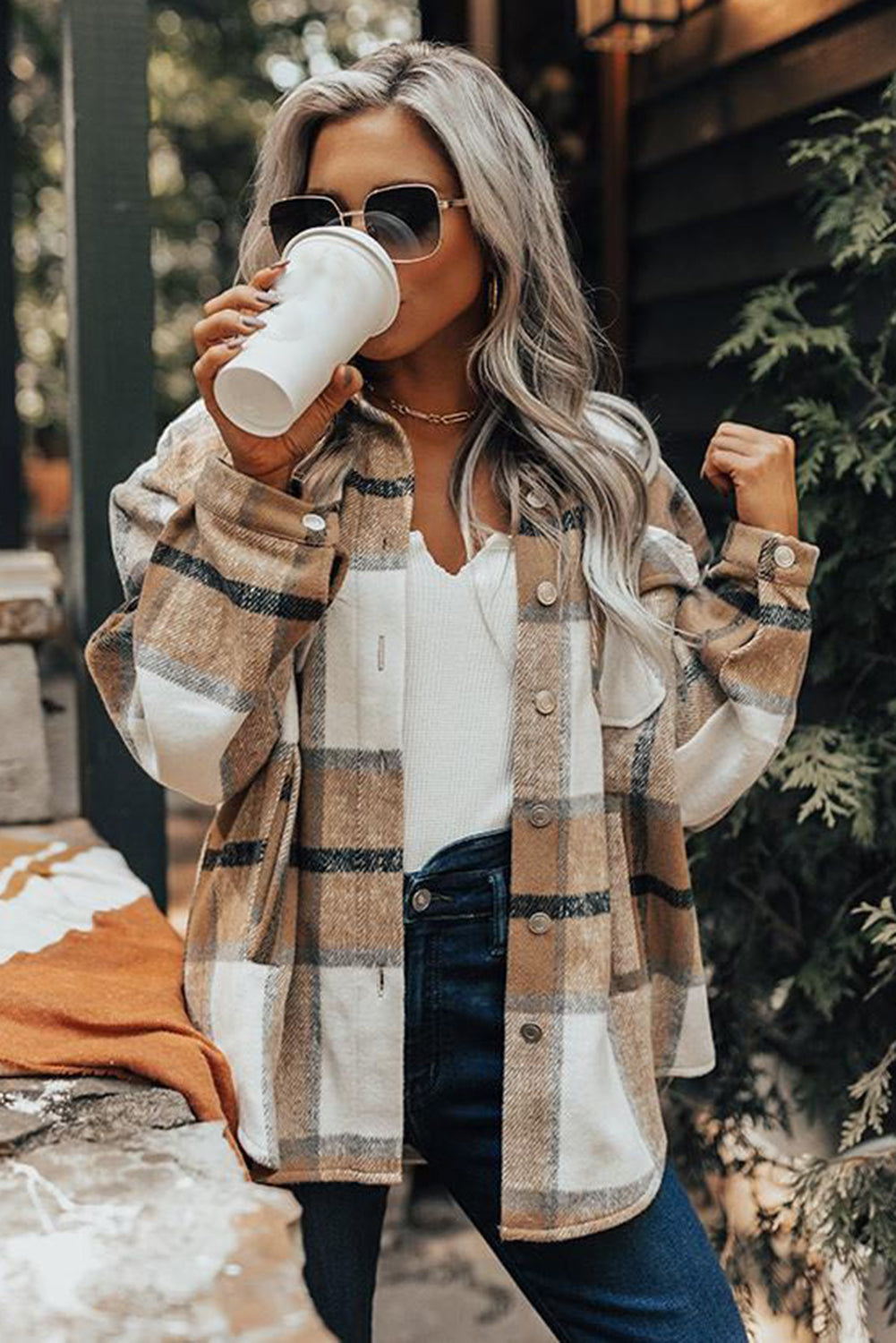 Khaki button-up pocket plaid shacket displayed on a mannequin, featuring a stylish plaid pattern and front pockets.