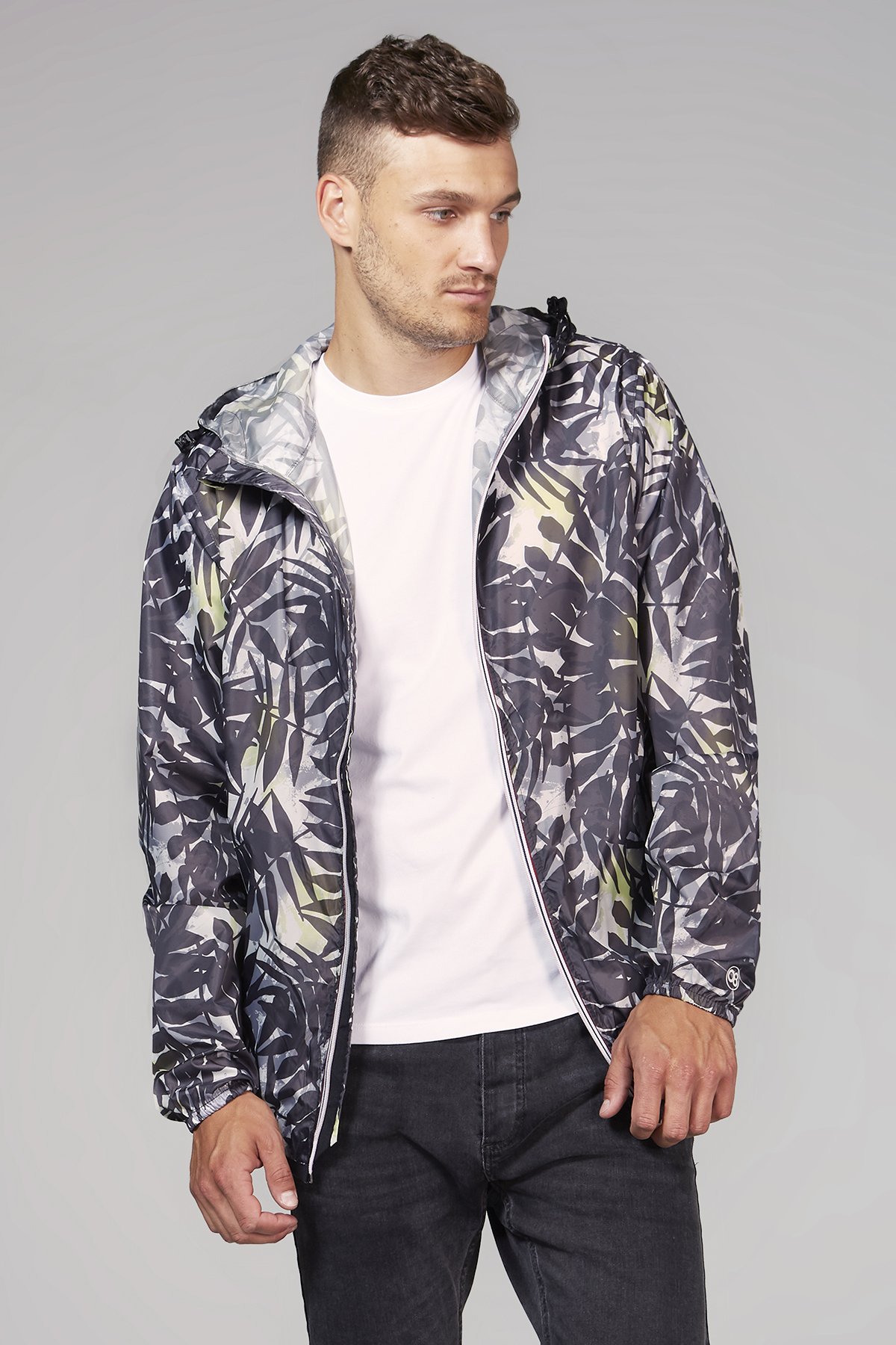 Men's palm print full zip packable rain jacket, showcasing its stylish design and practical features.