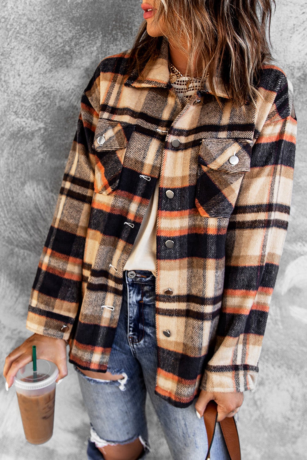 Orange geometric plaid shirt jacket with button front and large pockets, perfect for fall and winter wear.