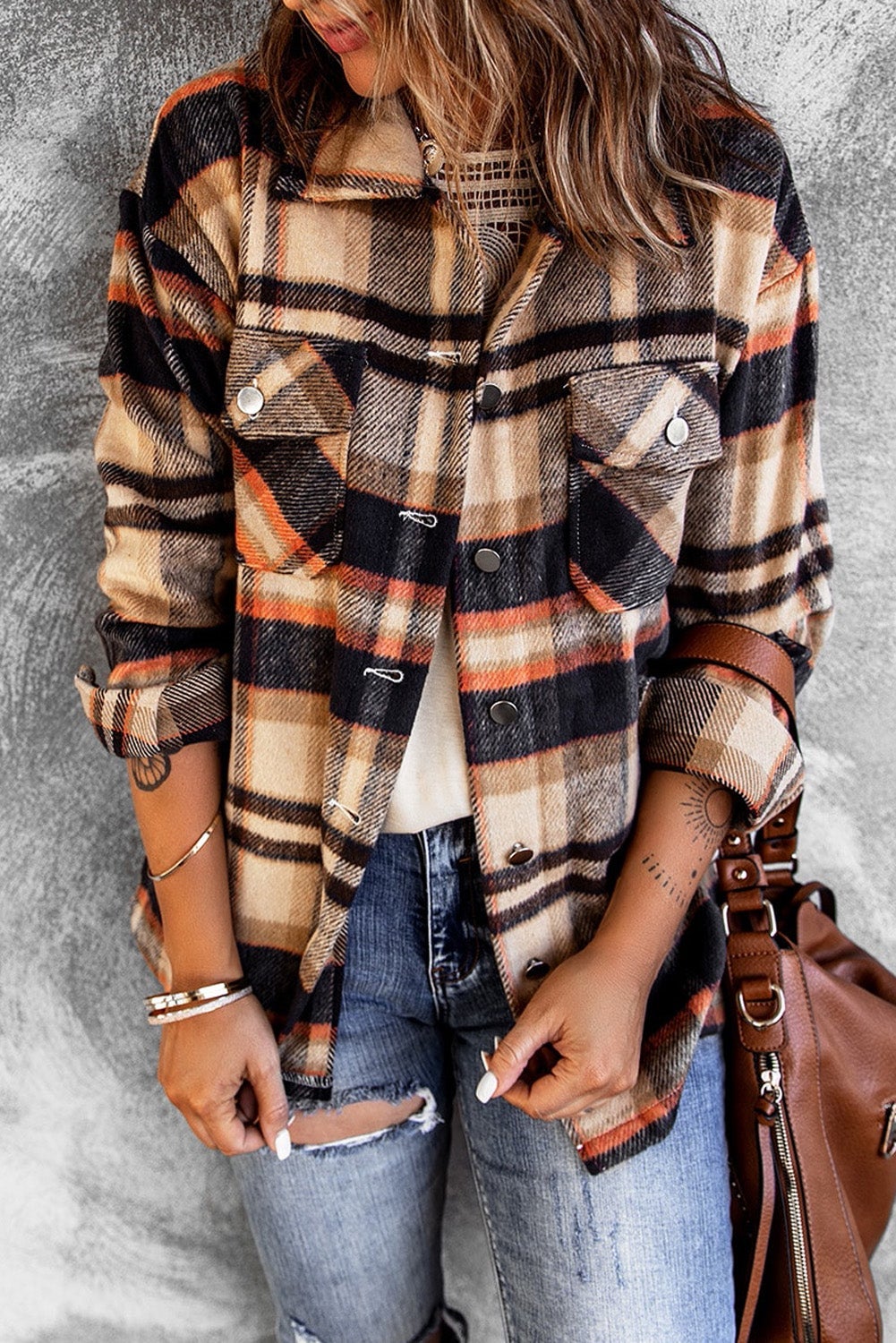 Orange geometric plaid shirt jacket with button front and large pockets, perfect for fall and winter wear.