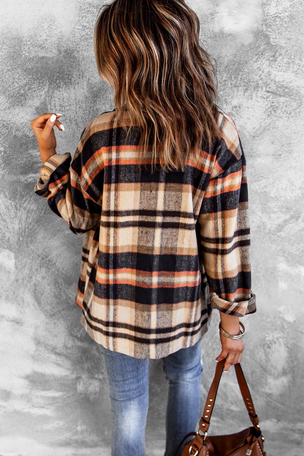 Orange geometric plaid shirt jacket with button front and large pockets, perfect for fall and winter wear.