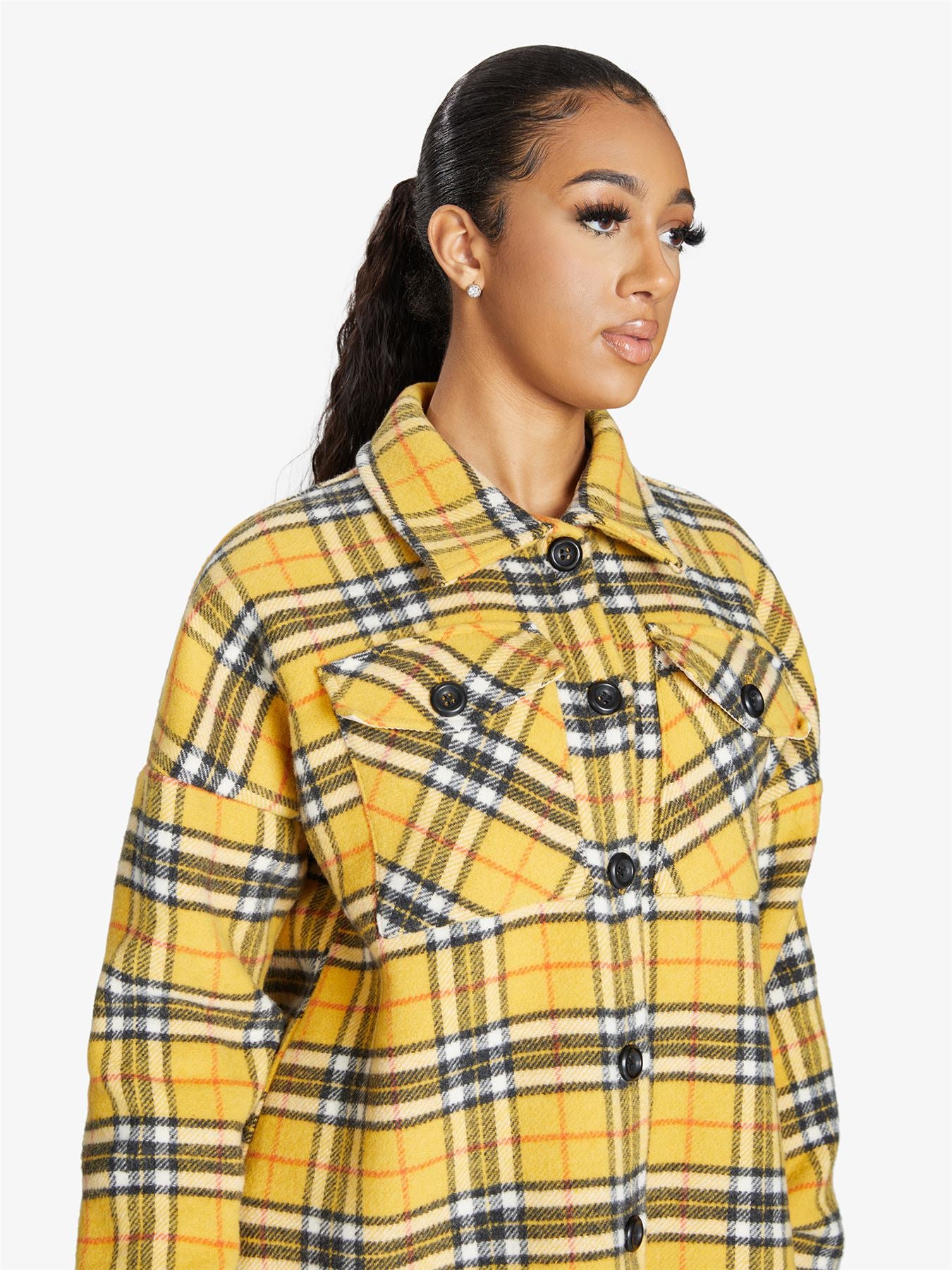 An oversized wool blend shacket featuring a luxurious nova check pattern, button down fastening, and a stylish design suitable for various occasions.