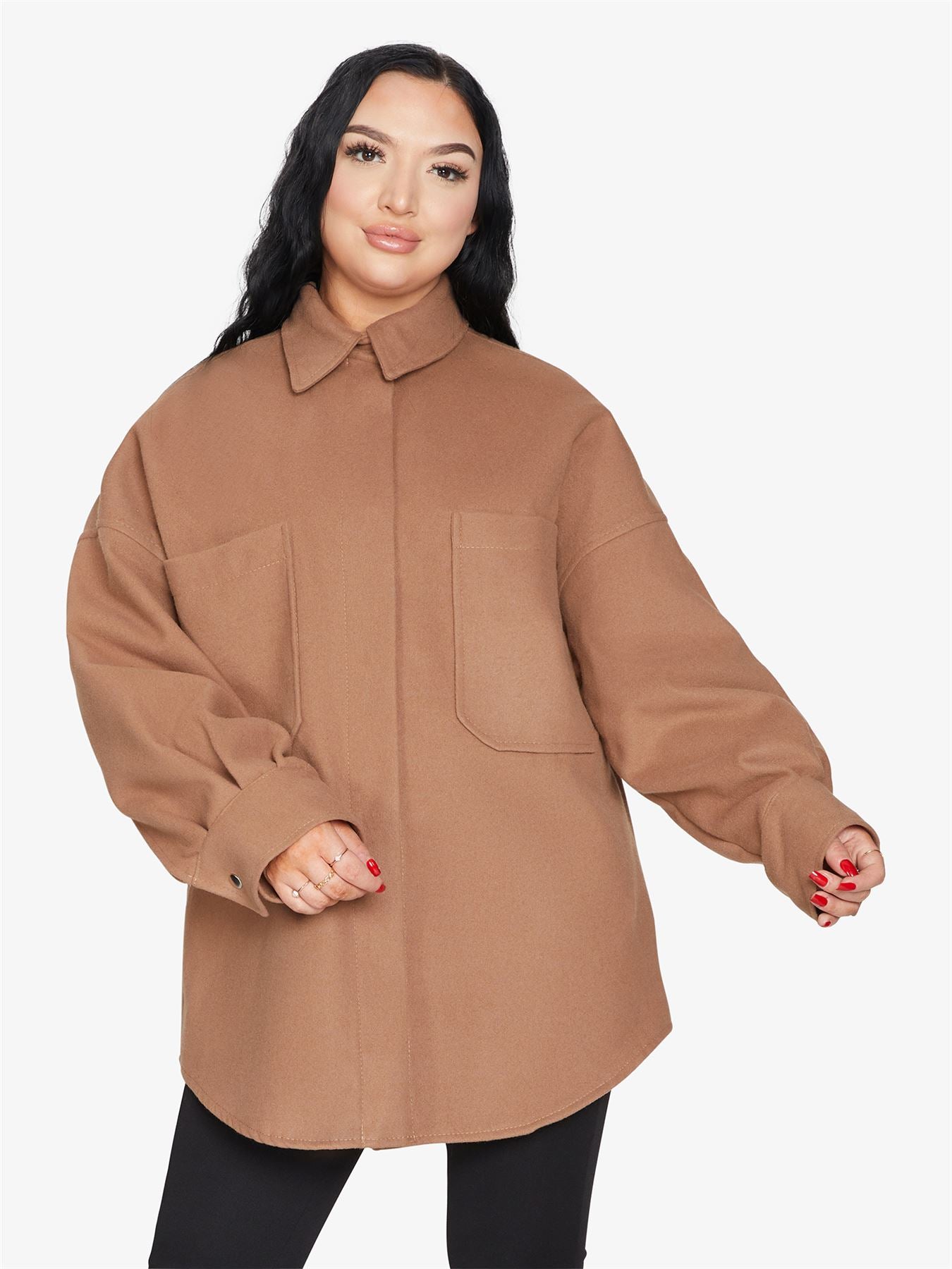 An oversized shacket featuring large patch pockets, stud button fastening, and a stylish collar, perfect for layering.