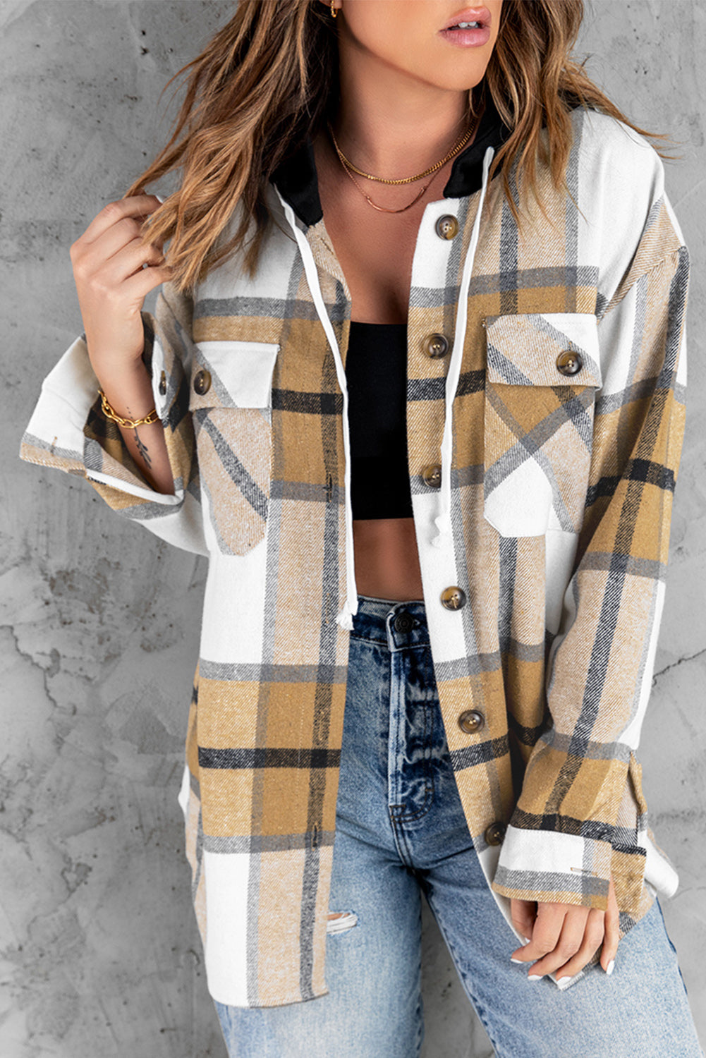 A stylish plaid hooded shirt jacket featuring long sleeves, button closure, and flap pockets, perfect for casual wear.