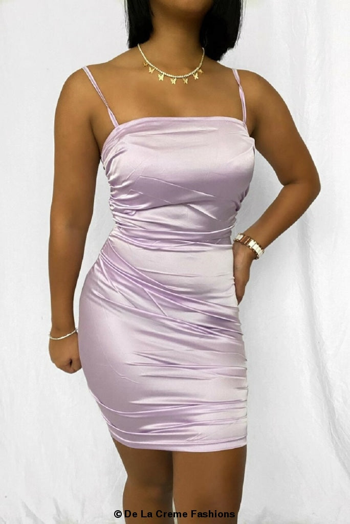 A stylish Ruched Satin Mini Dress in lilac, showcasing its elegant design and flattering fit.