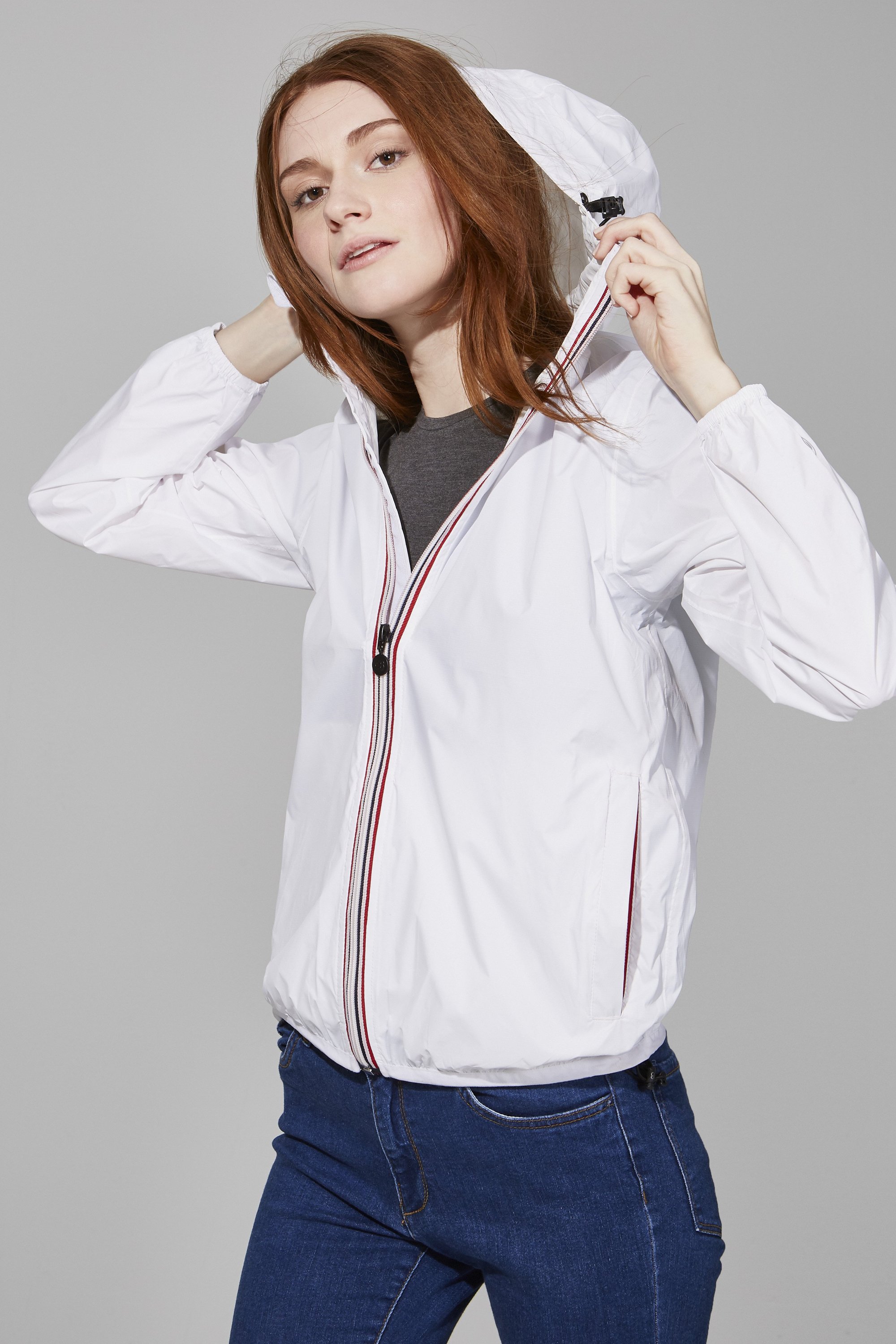 White Full Zip Packable Rain Jacket displayed on a mannequin, showcasing its ergonomic hood, custom zipper, and hidden side pockets.