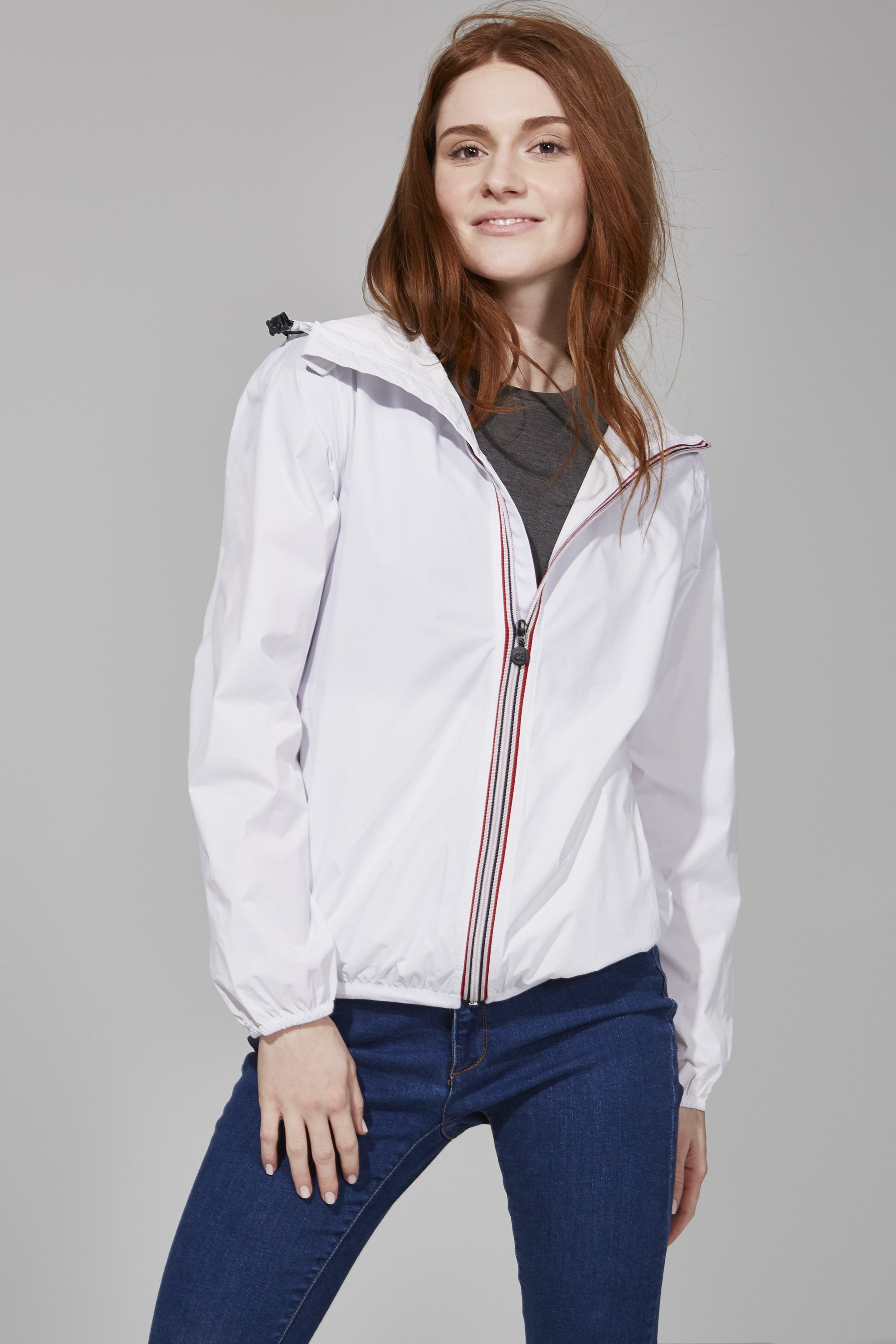 White Full Zip Packable Rain Jacket displayed on a mannequin, showcasing its ergonomic hood, custom zipper, and hidden side pockets.