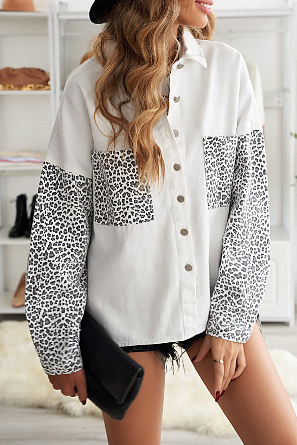 White denim shirt jacket with leopard print sleeves, featuring front snap closures and pockets.