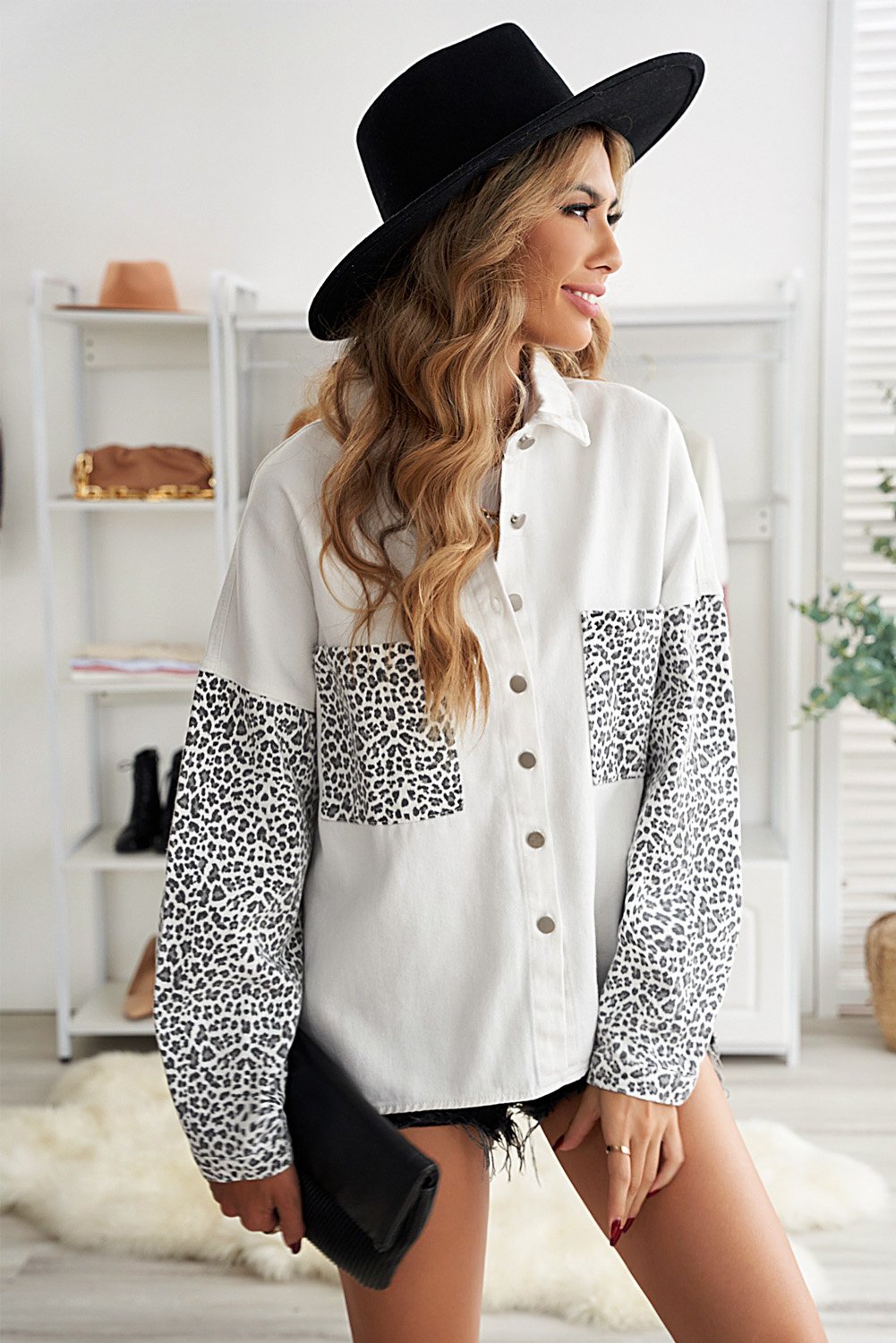 White denim shirt jacket with leopard print sleeves, featuring front snap closures and pockets.