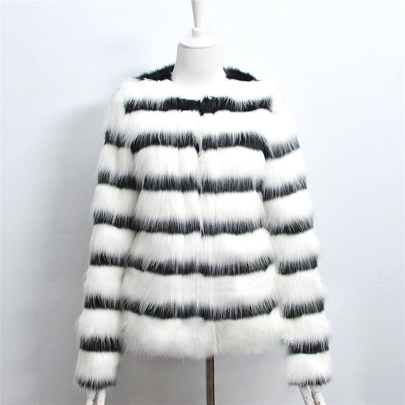 Elegant women's winter coat featuring black and white stripes made of soft faux fur, designed for warmth and style.