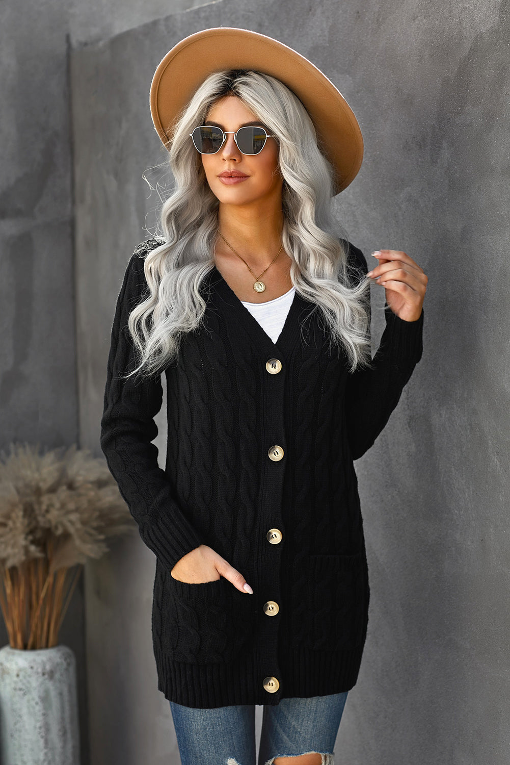 A stylish Winter Black Button Pocket Knit Cardigan featuring a chunky knit design, long sleeves, and front pockets, perfect for layering in cold weather.