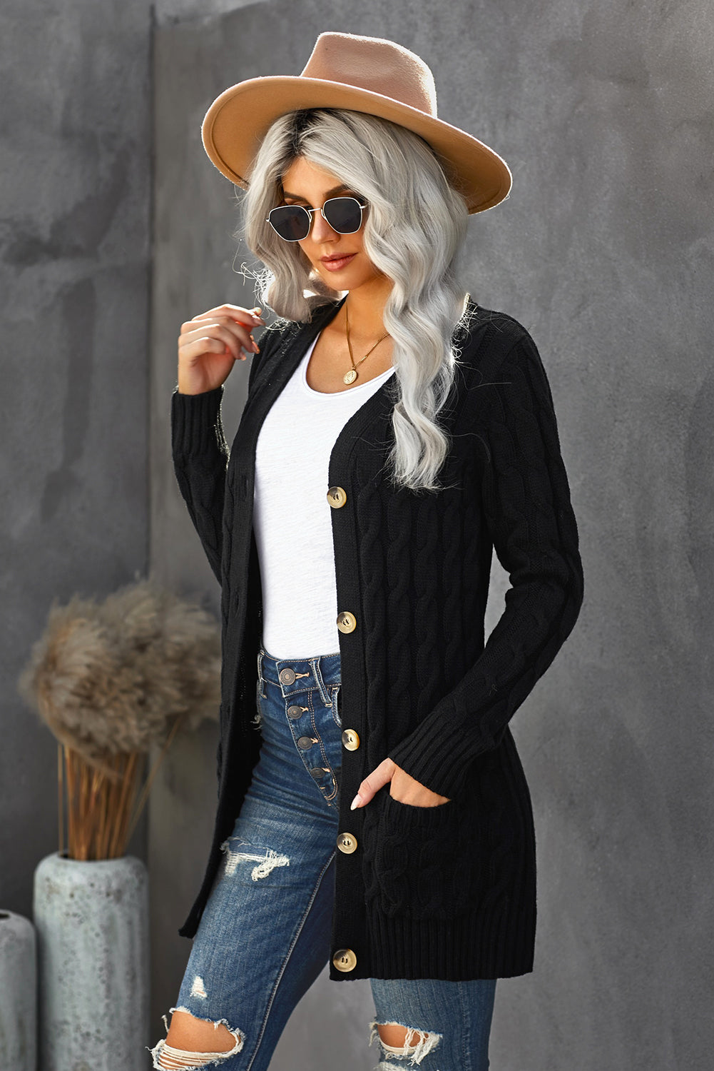 A stylish Winter Black Button Pocket Knit Cardigan featuring a chunky knit design, long sleeves, and front pockets, perfect for layering in cold weather.