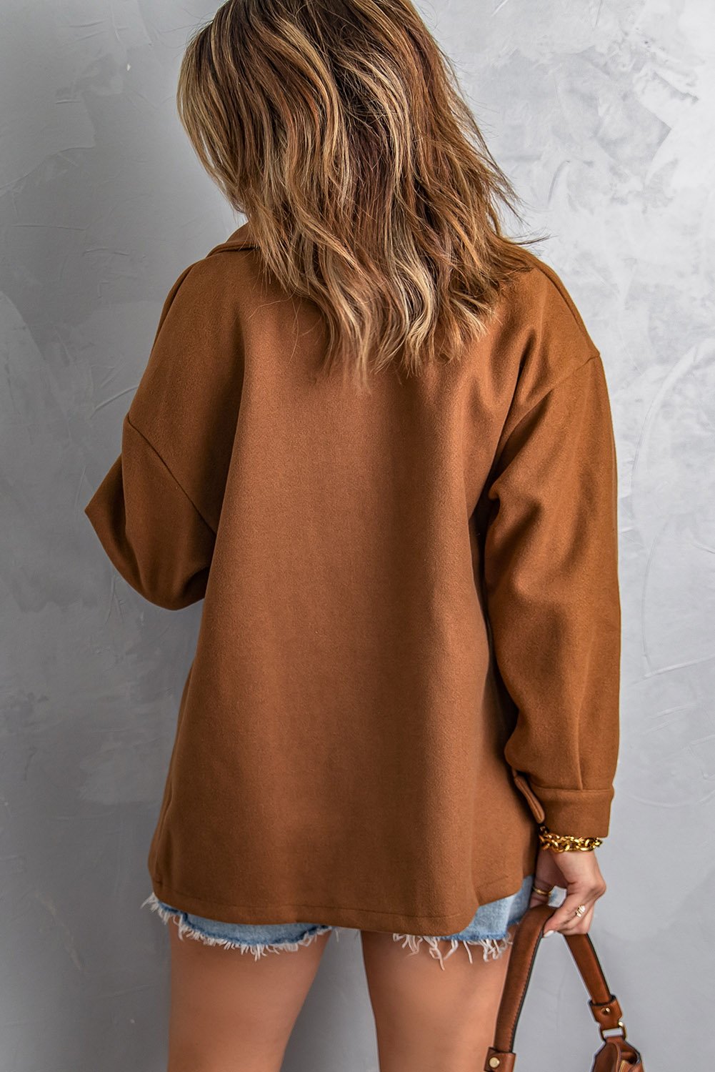 A stylish brown baggy coat with full sleeves, buttoned closure, and flap pockets, perfect for winter wear.