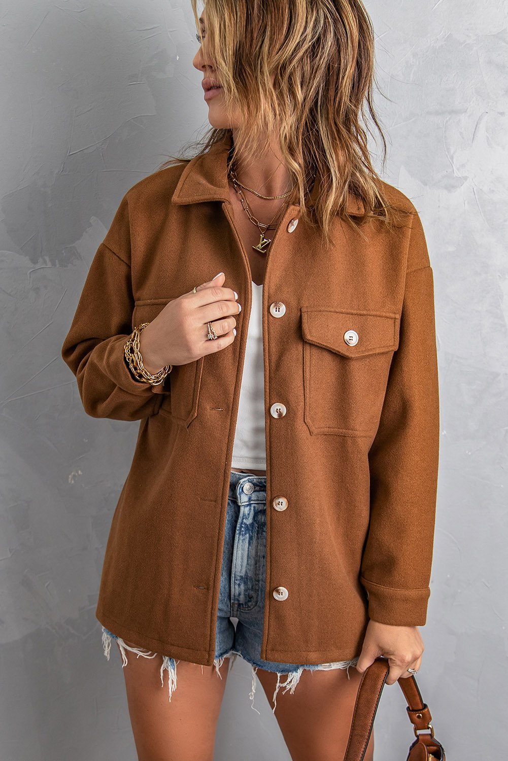 A stylish brown baggy coat with full sleeves, buttoned closure, and flap pockets, perfect for winter wear.