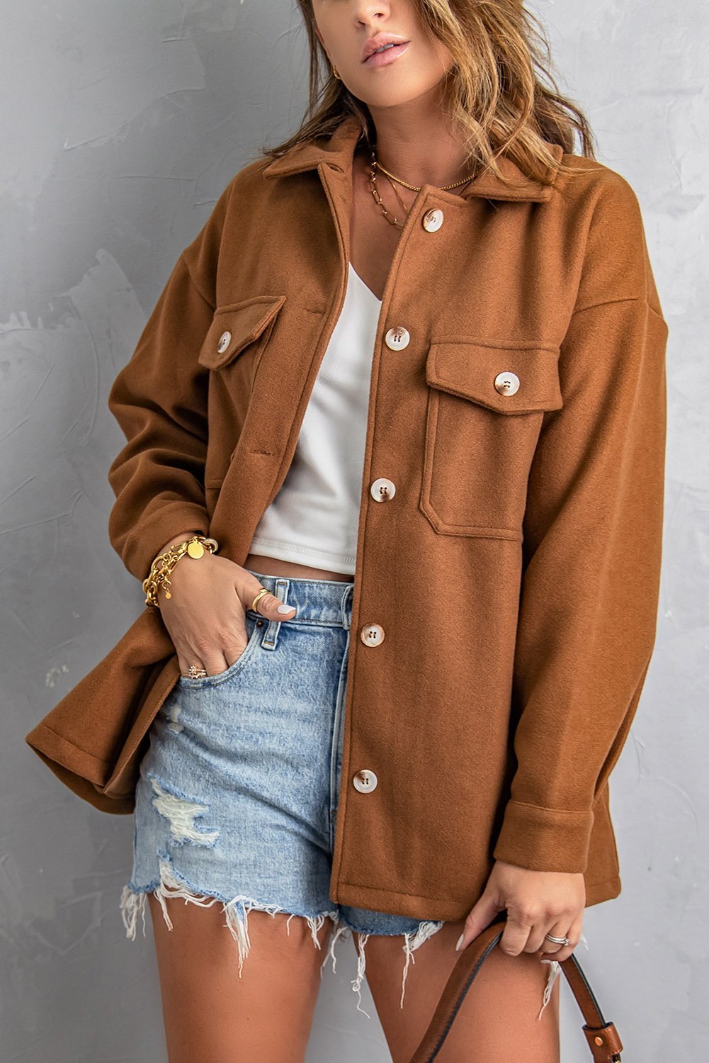 A stylish brown baggy coat with full sleeves, buttoned closure, and flap pockets, perfect for winter wear.