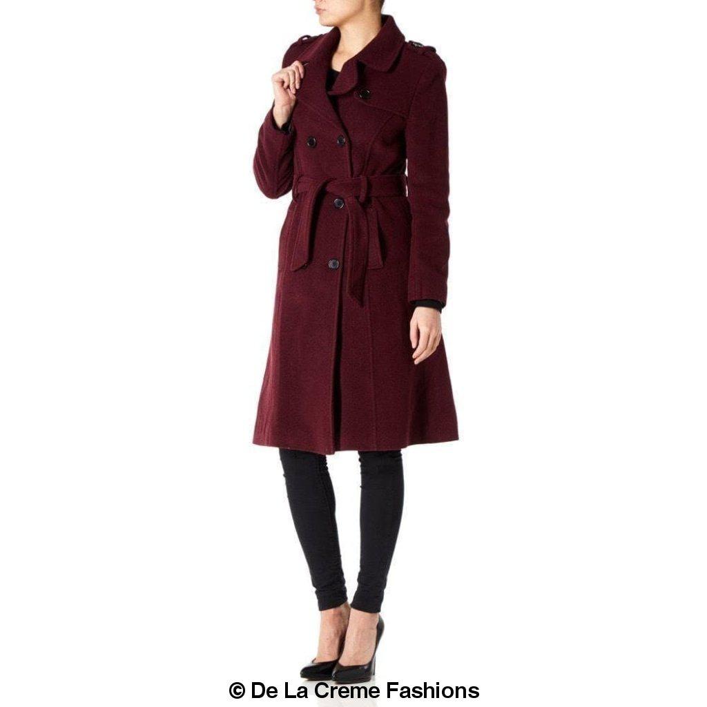 A stylish women's military coat made from a luxurious wool and cashmere blend, featuring double-breasted fastening, military epaulettes, and knee-length design.