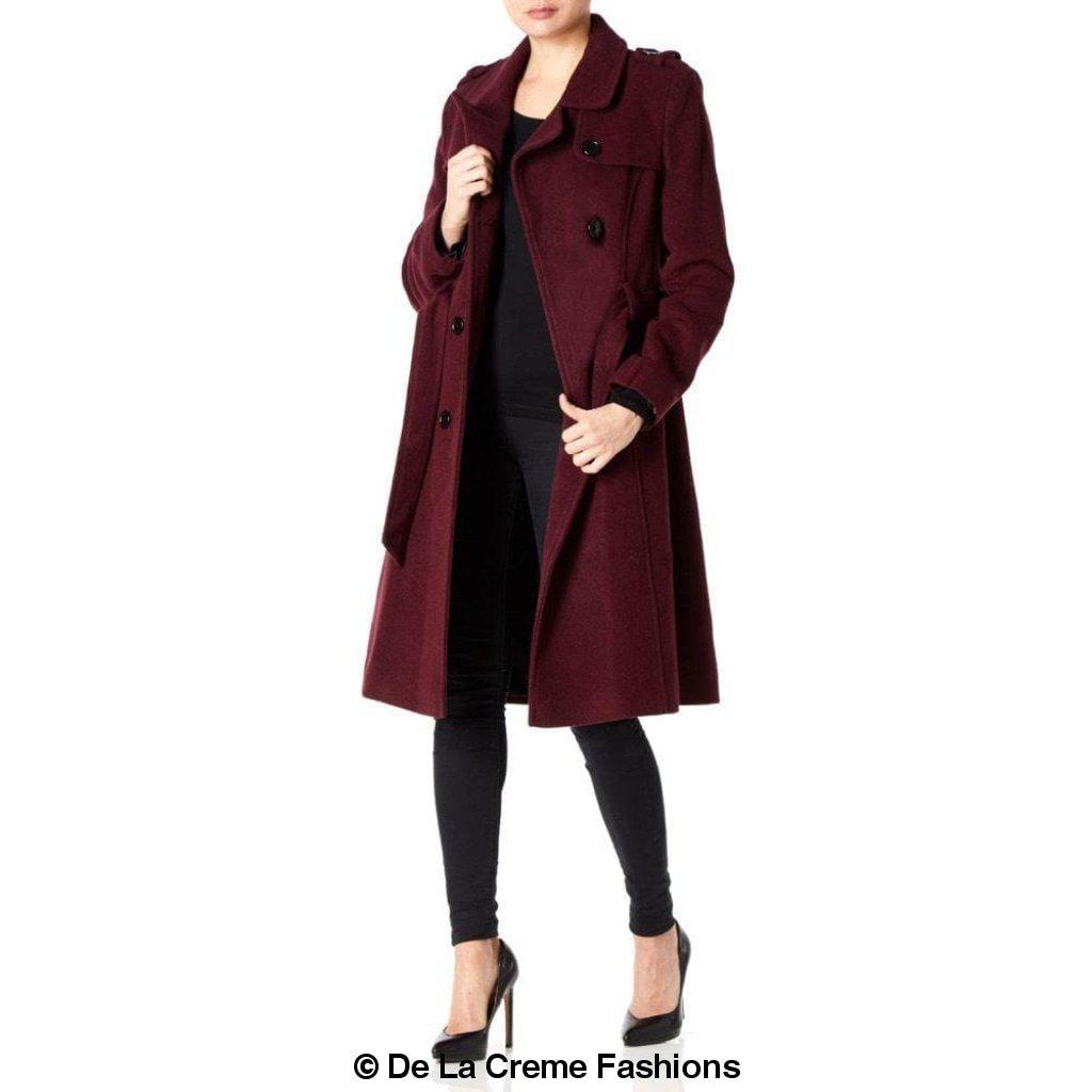 A stylish women's military coat made from a luxurious wool and cashmere blend, featuring double-breasted fastening, military epaulettes, and knee-length design.