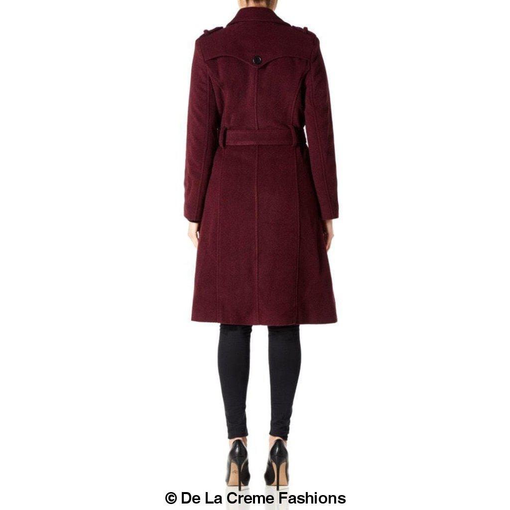 A stylish women's military coat made from a luxurious wool and cashmere blend, featuring double-breasted fastening, military epaulettes, and knee-length design.