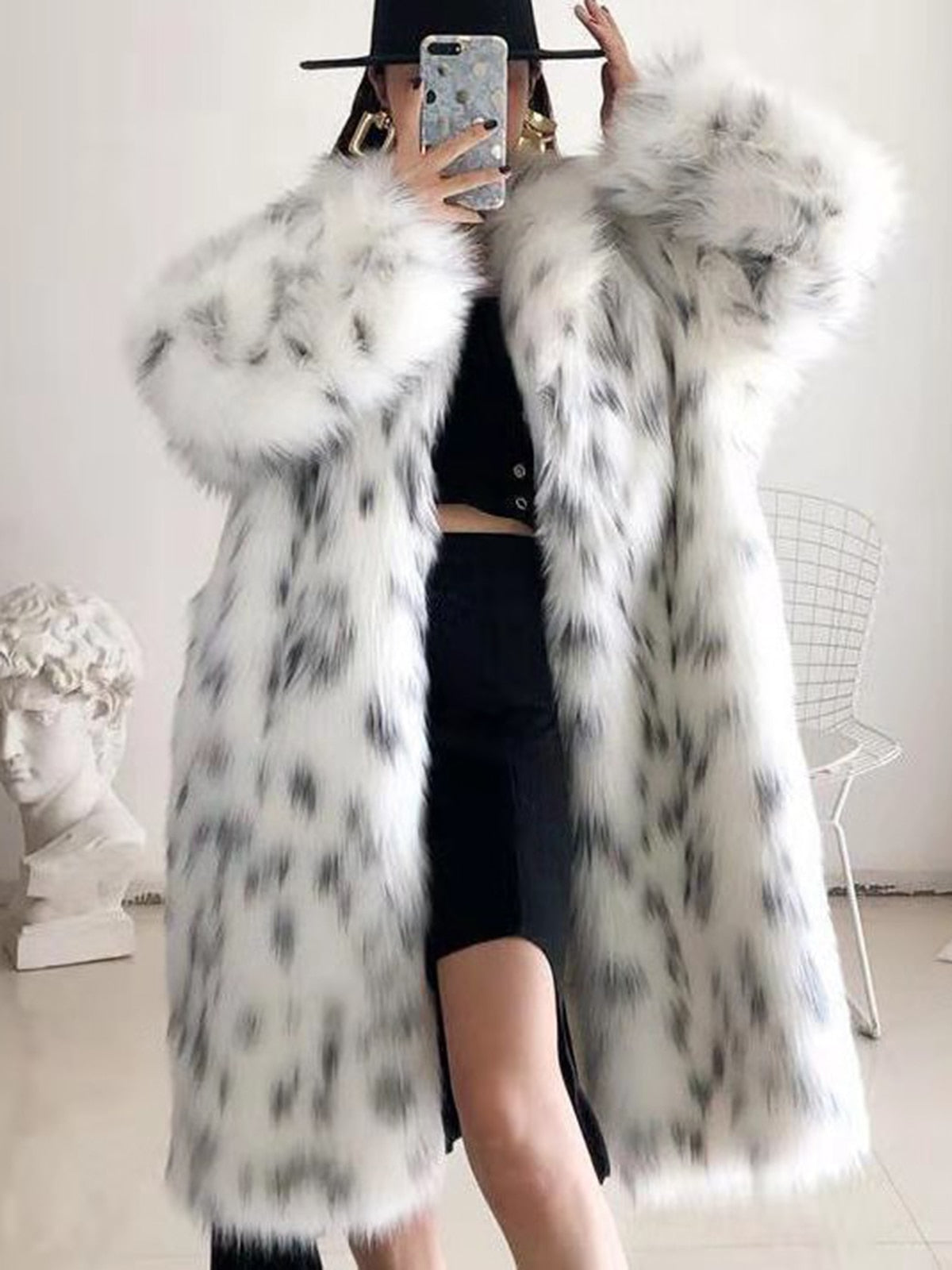 Women wearing a stylish snow leopard print faux fox fur coat, showcasing its luxurious texture and elegant design.