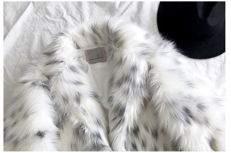 Women wearing a stylish snow leopard print faux fox fur coat, showcasing its luxurious texture and elegant design.