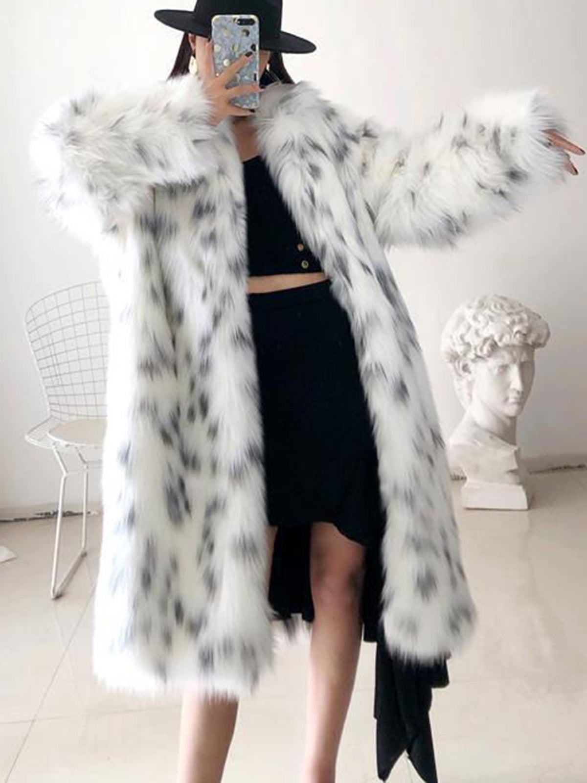 Women wearing a stylish snow leopard print faux fox fur coat, showcasing its luxurious texture and elegant design.