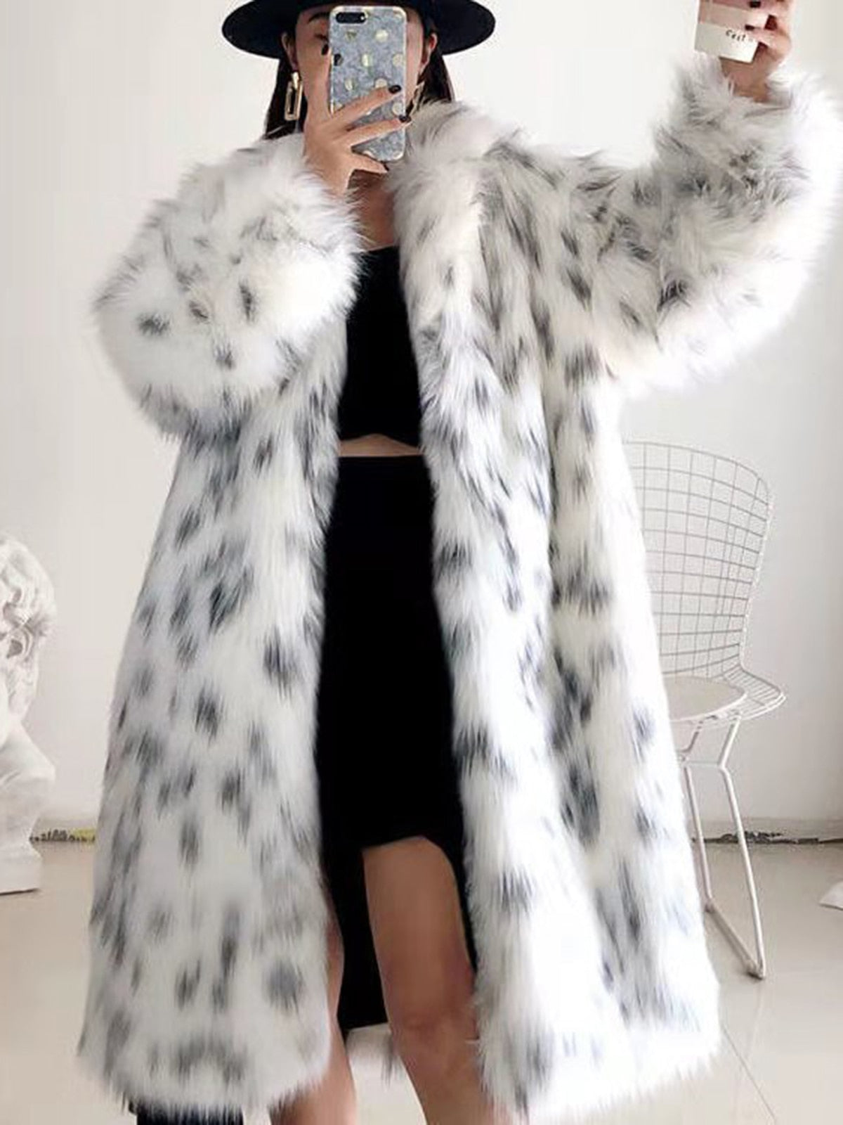 Women wearing a stylish snow leopard print faux fox fur coat, showcasing its luxurious texture and elegant design.