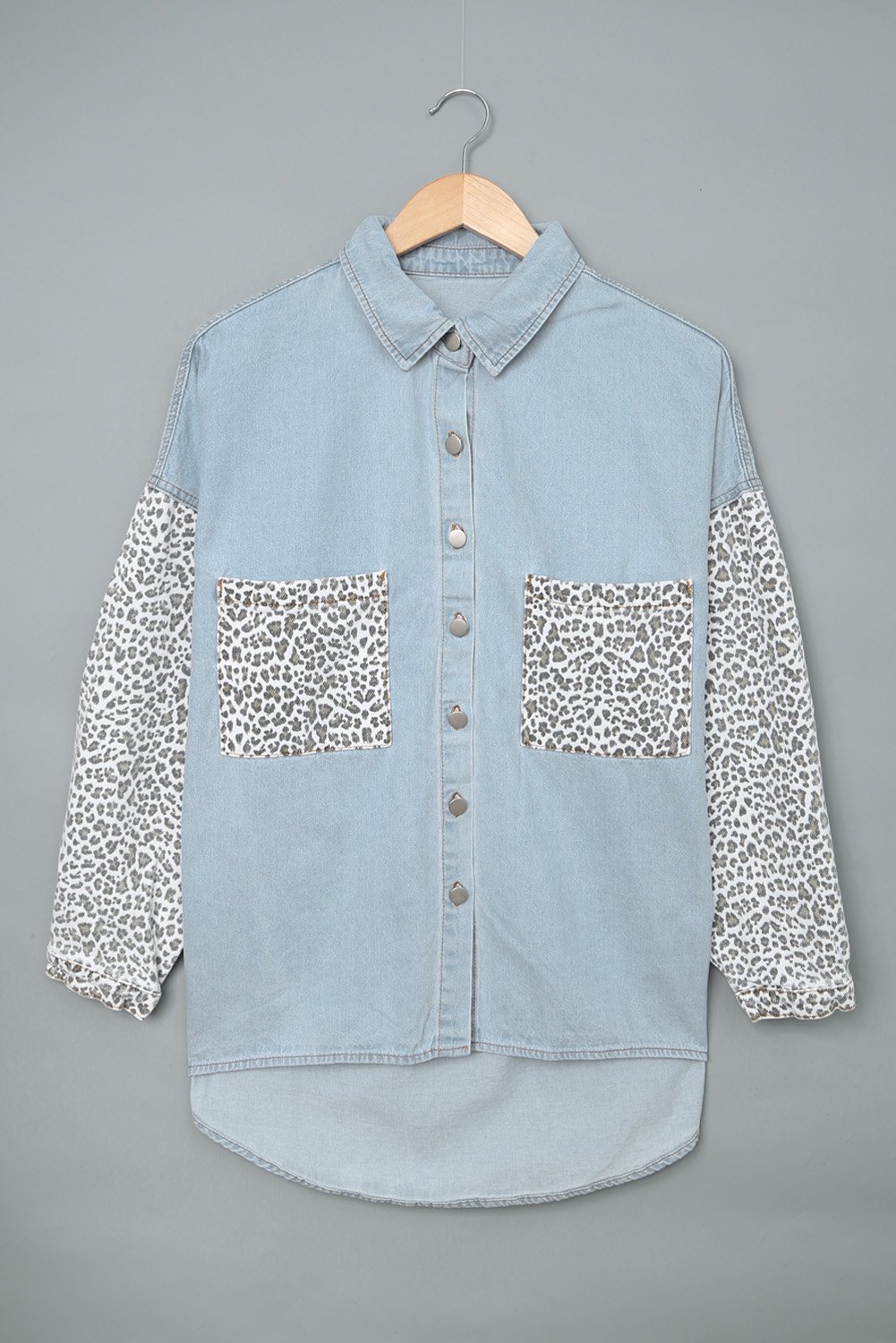 Women's Sky Blue Contrast Leopard Denim Jacket featuring leopard print sleeves and front snap closures, perfect for casual winter wear.