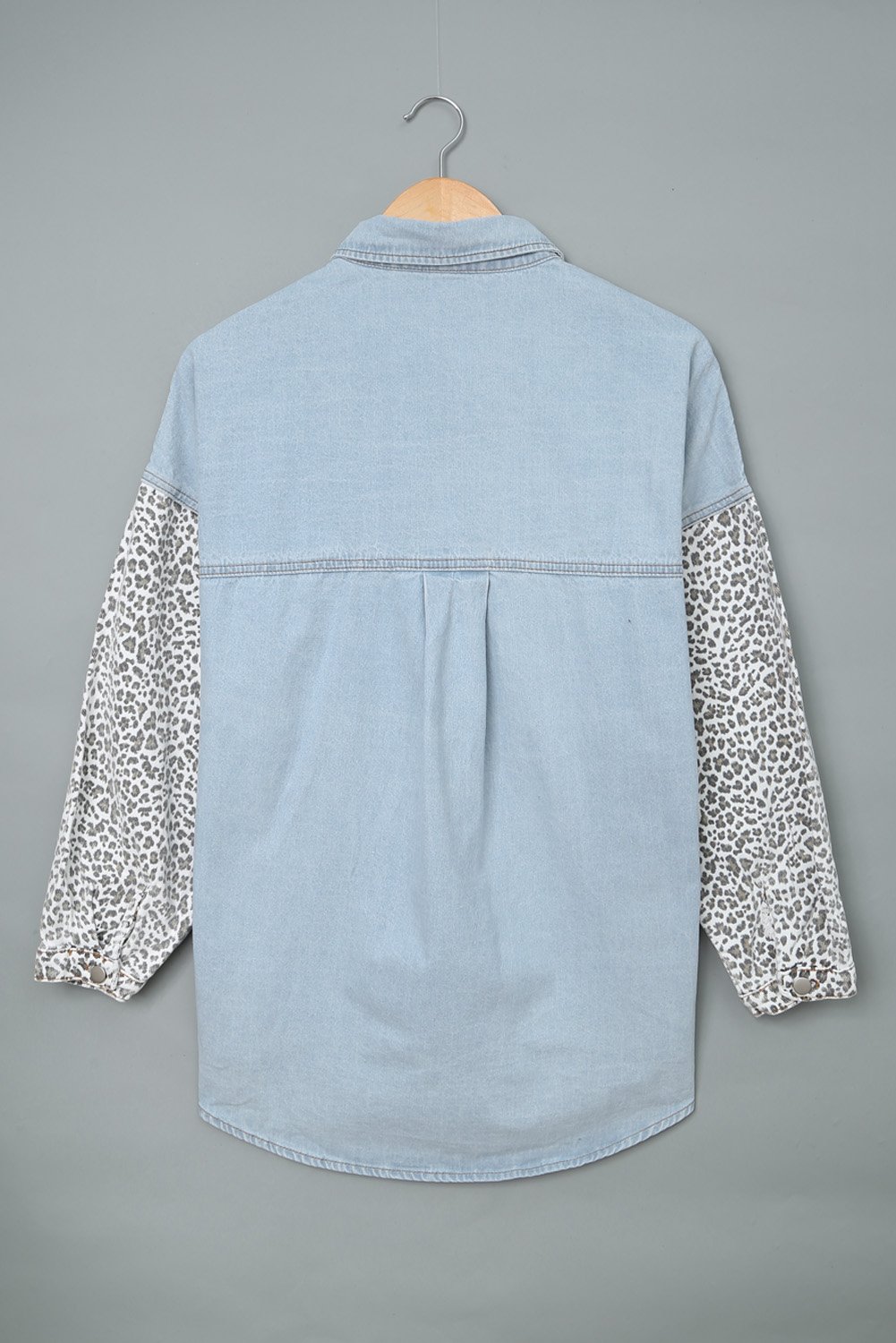 Women's Sky Blue Contrast Leopard Denim Jacket featuring leopard print sleeves and front snap closures, perfect for casual winter wear.