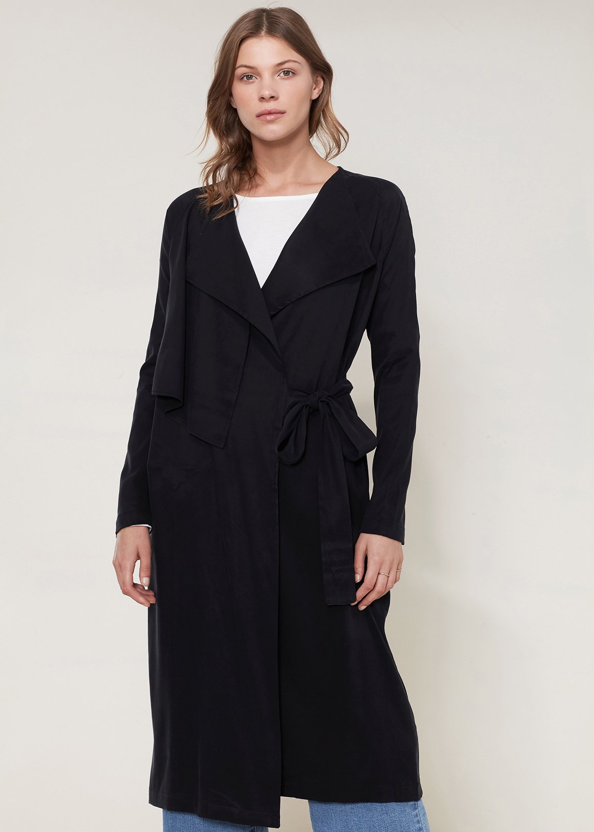 Women's black wrap trench coat featuring a drape collar and side pockets, elegantly tied at the waist.