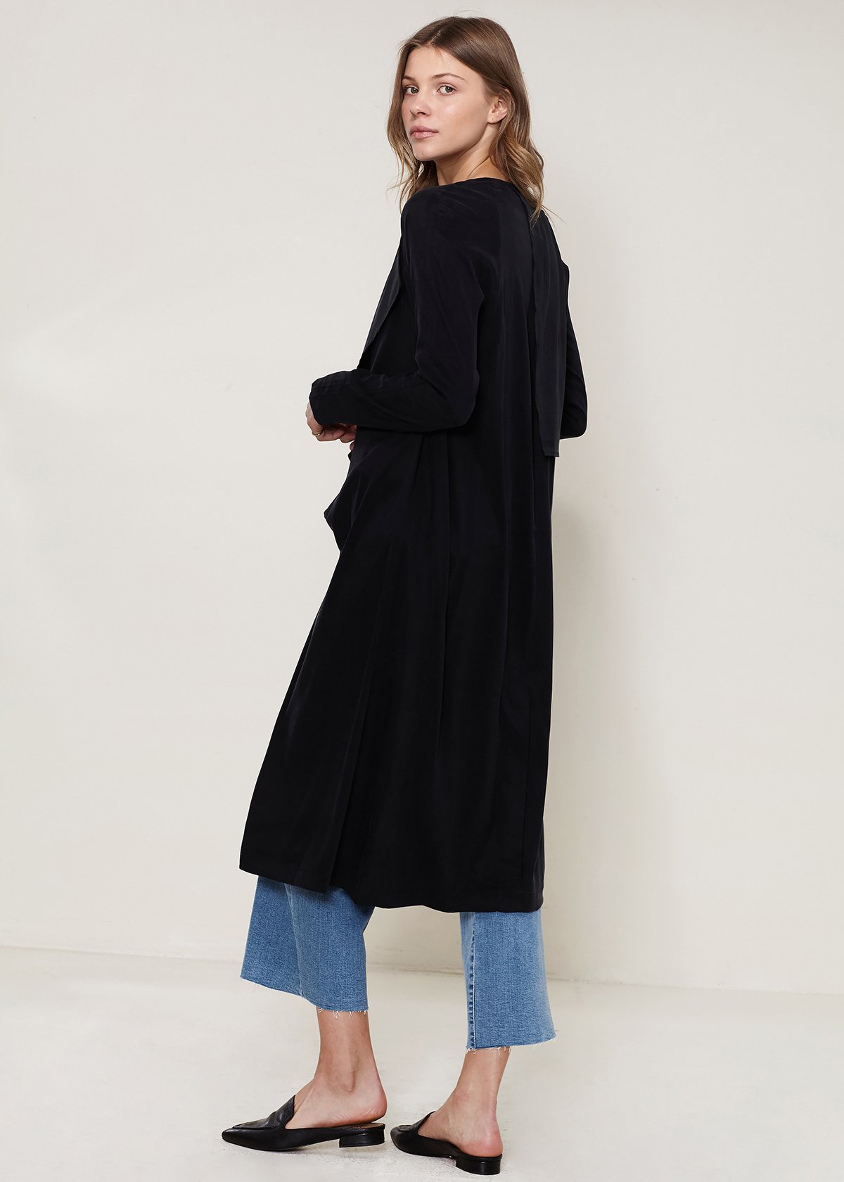 Women's black wrap trench coat featuring a drape collar and side pockets, elegantly tied at the waist.