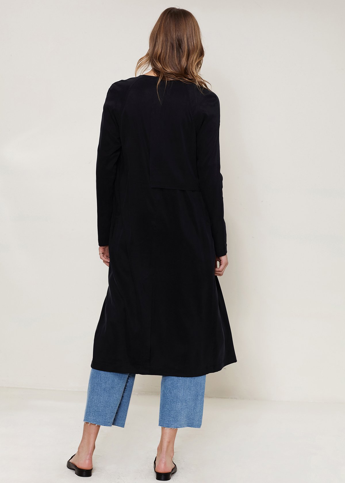 Women's black wrap trench coat featuring a drape collar and side pockets, elegantly tied at the waist.