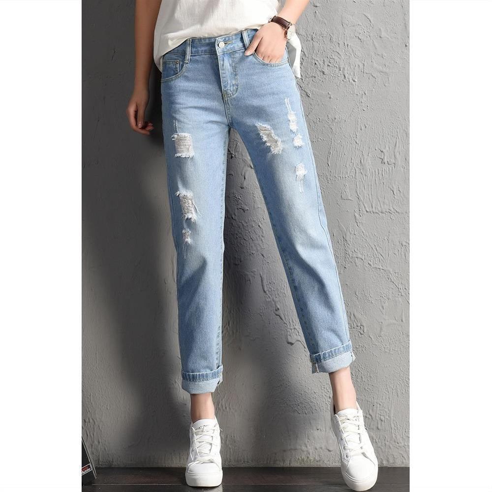 A pair of stylish mid-waist boyfriend jeans featuring big ripped holes, made from a soft cotton-polyester blend, perfect for casual wear.