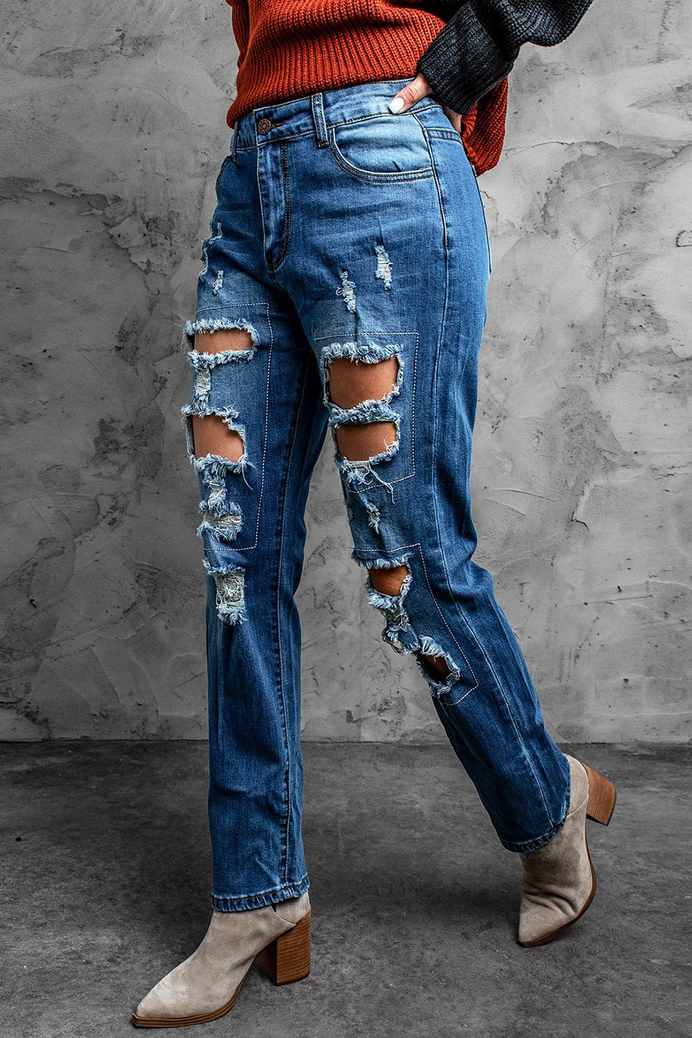 A pair of blue distressed ripped jeans showcasing stylish rips and a casual fit, perfect for various occasions.