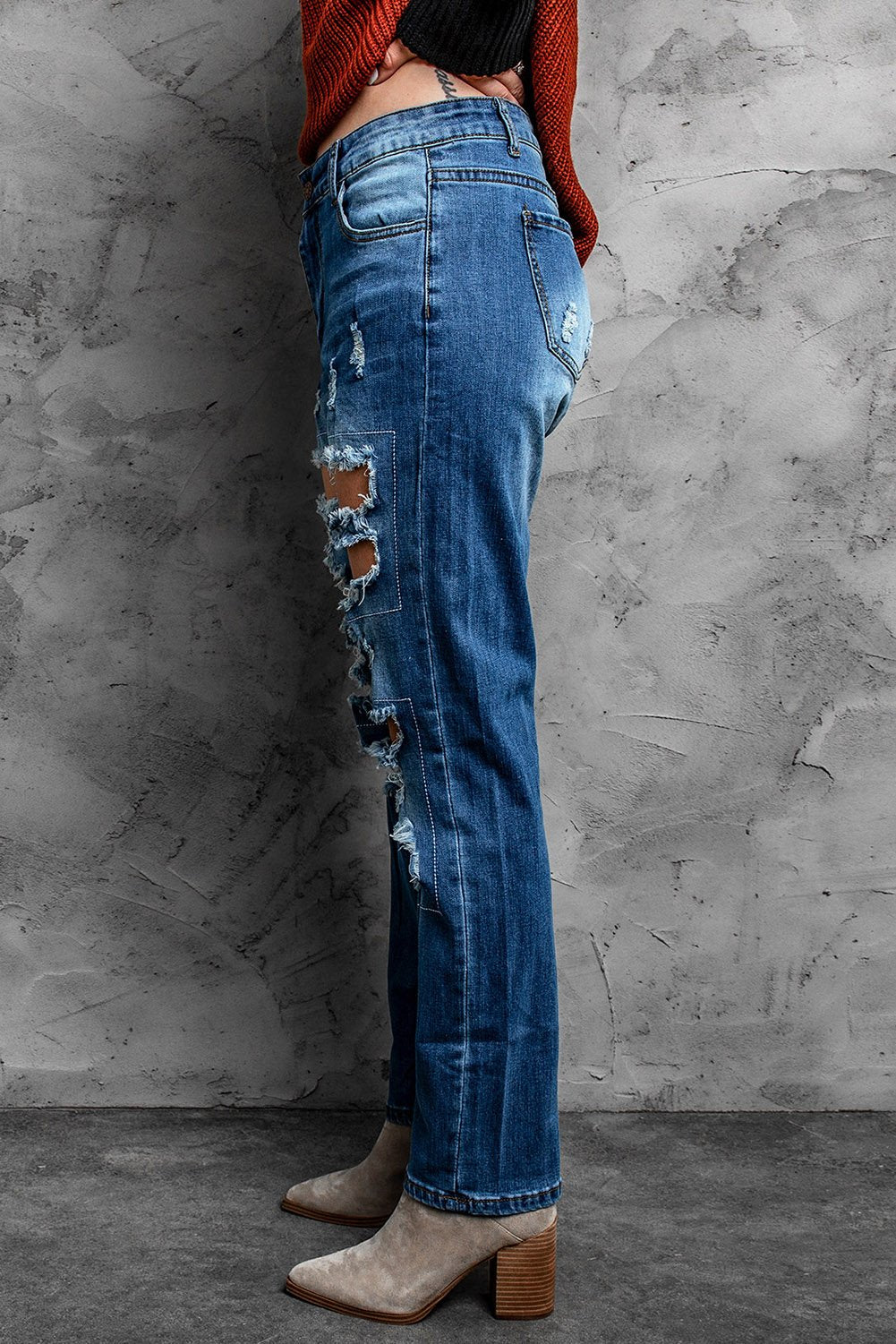 A pair of blue distressed ripped jeans showcasing stylish rips and a casual fit, perfect for various occasions.