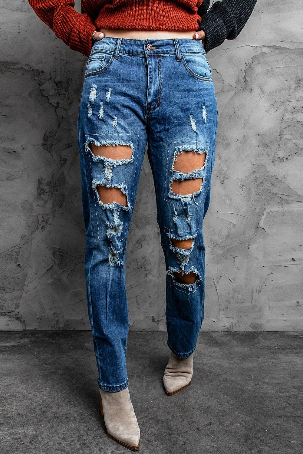 A pair of blue distressed ripped jeans showcasing stylish rips and a casual fit, perfect for various occasions.