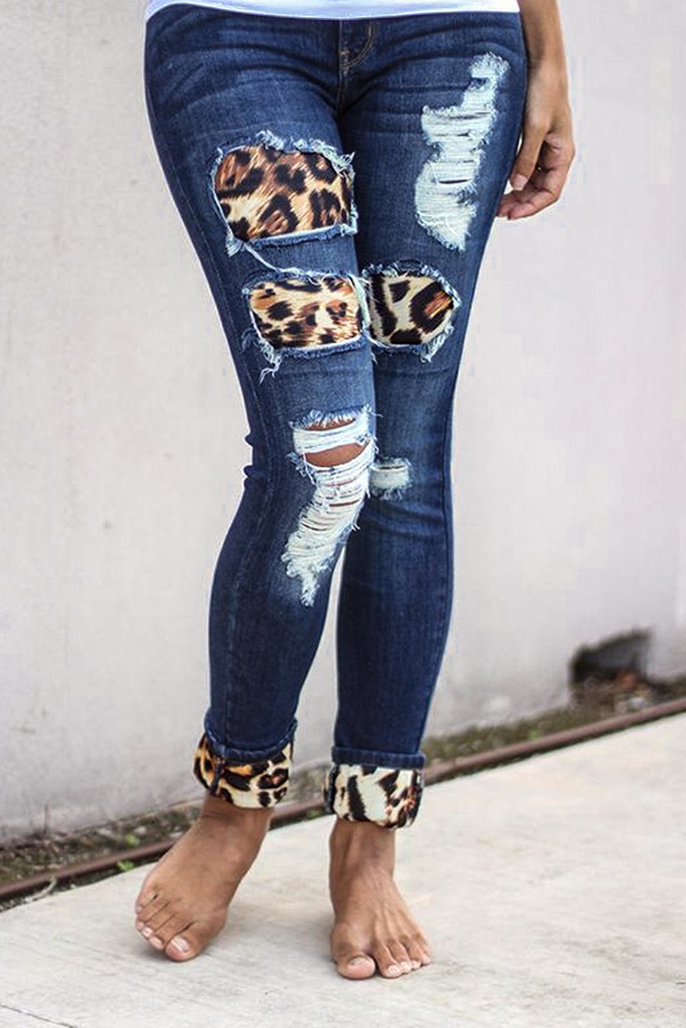 Fashion Women's Blue Hollow Out Leopard Splice Ripped Jeans showcasing a trendy design with hollow-out details and leopard splicing, perfect for casual wear.