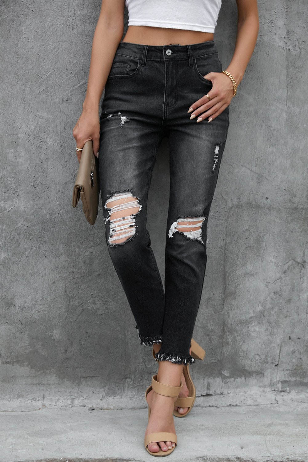 A pair of stylish black mid waist jeans featuring a straight leg design, light distressing, and functional pockets, perfect for casual wear.