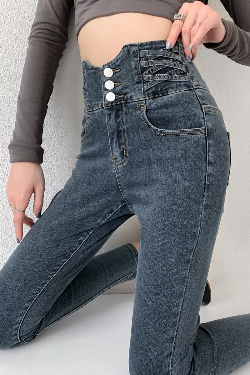 Skinny pencil jeans featuring a vintage high waist design with four buttons, made from stretchy cotton denim, perfect for a stylish look.