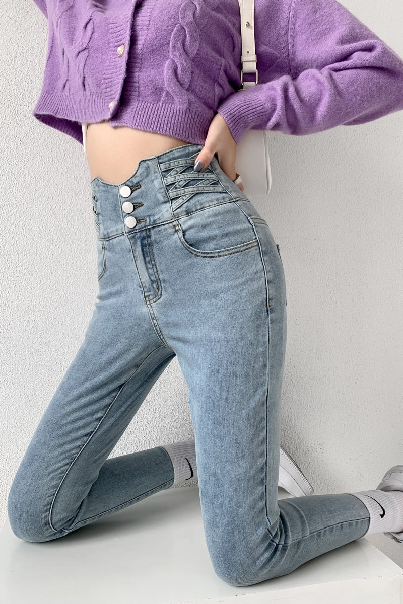 Skinny pencil jeans featuring a vintage high waist design with four buttons, made from stretchy cotton denim, perfect for a stylish look.