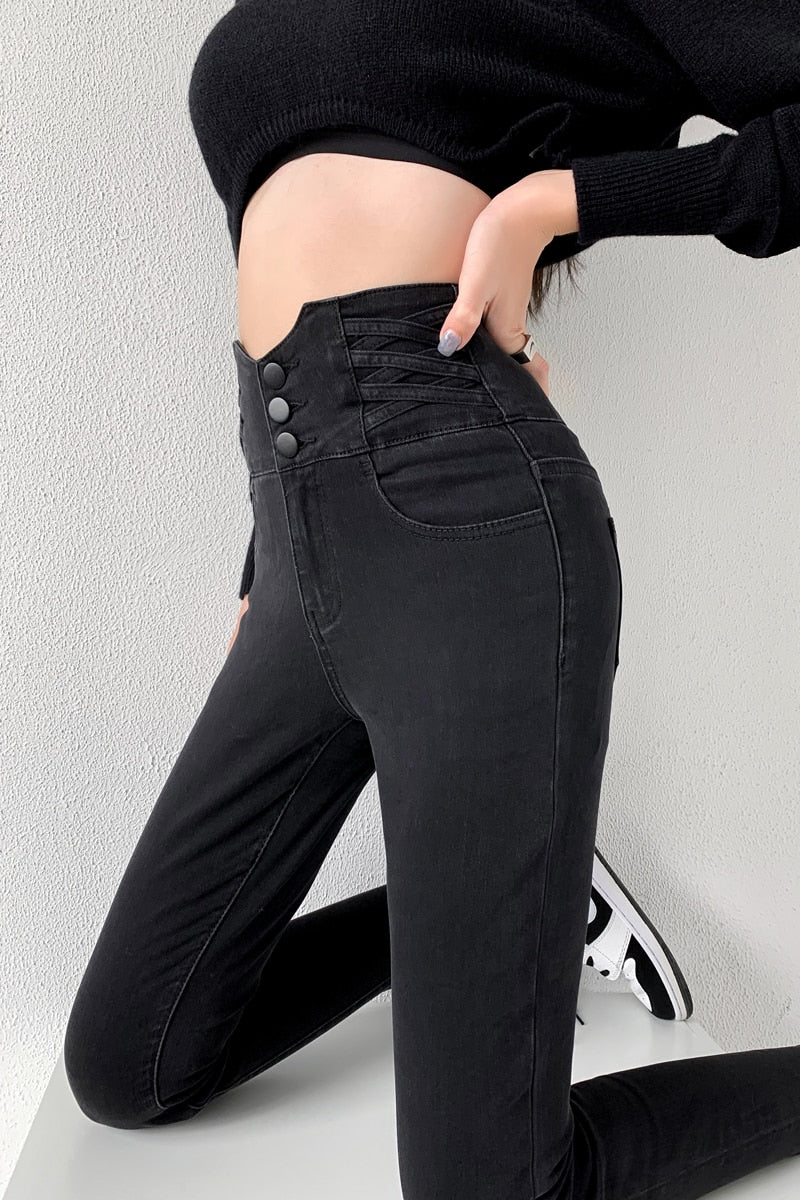 Skinny pencil jeans featuring a vintage high waist design with four buttons, made from stretchy cotton denim, perfect for a stylish look.