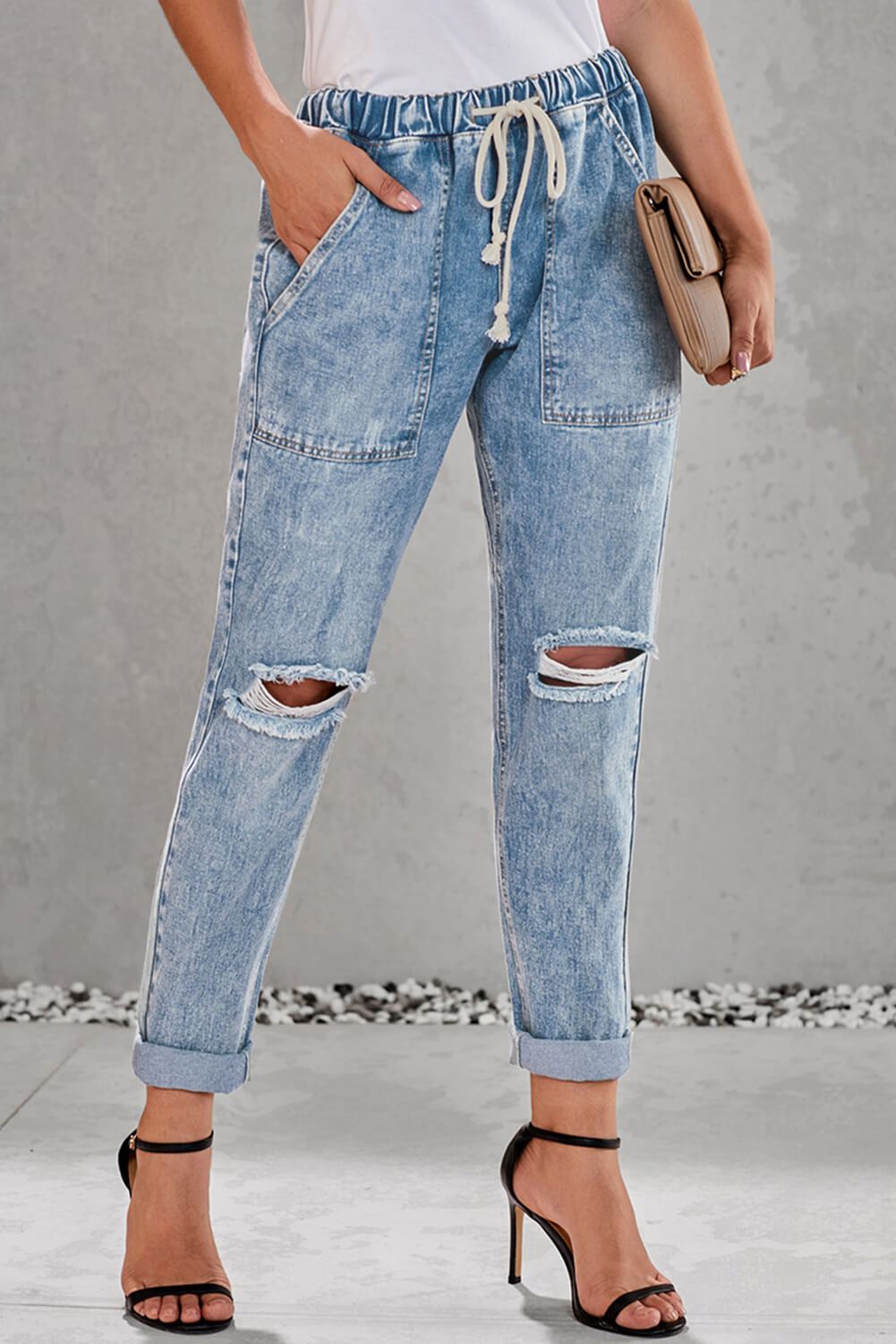 Sky Blue Gather Round Distressed Pocketed Hole Denim Jogger featuring an elastic drawstring waist, light distressing, and functional pockets.