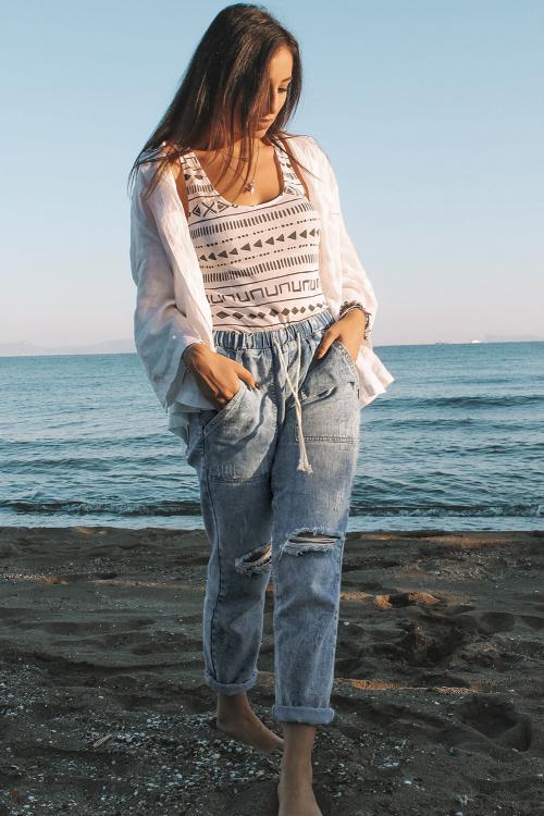 Sky Blue Gather Round Distressed Pocketed Hole Denim Jogger featuring an elastic drawstring waist, light distressing, and functional pockets.