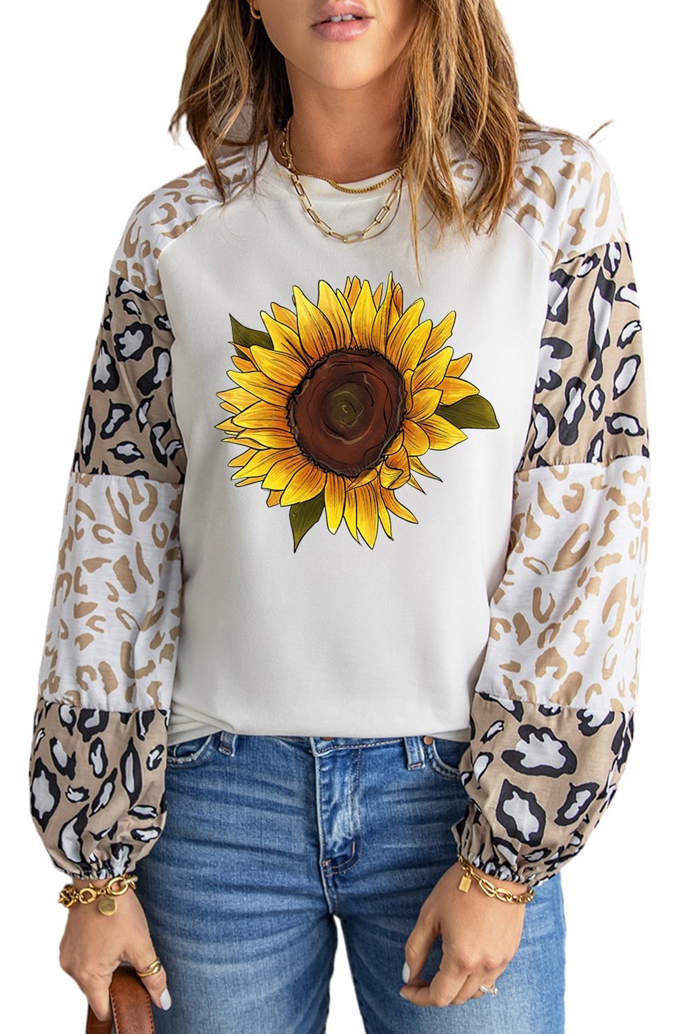 A stylish beige long sleeve top featuring sunflower and leopard prints, designed with bubble sleeves and a loose pullover silhouette.