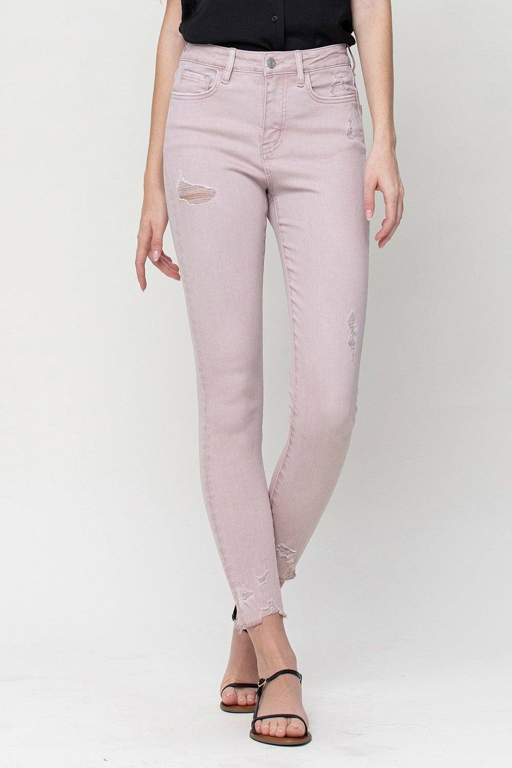 A pair of Vervet Peony Distressed Jeans showcasing a soft peony color with subtle distressing, perfect for spring and summer fashion.