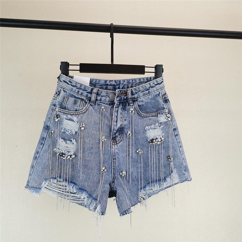 Women luxurious tassel rhinestone fringed hole jeans shorts, high waist design, showcasing stylish details and a flattering fit.